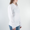 White polo shirt seen from the side. A woman is wearing it.