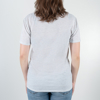 Back of the white shirt. A woman is wearing it.