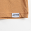 Close-up of the shirt's tag. A white rectangle with "James B. Beam" written in black.