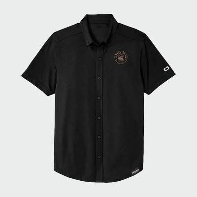 A black polo t-shirt with “Little Book” written inside a golden circle on the left peck.