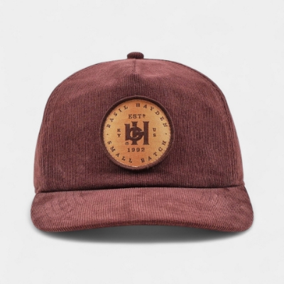 Basil Hayden brown corduroy hat with leather and brass snap closure
