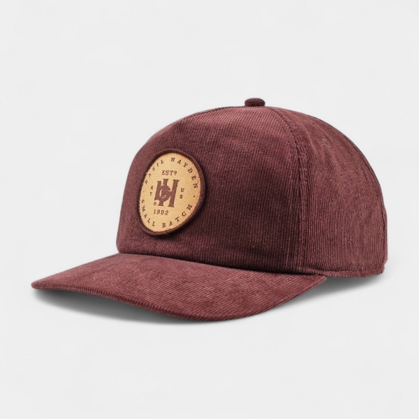 Basil Hayden brown corduroy hat with leather and brass snap closure
