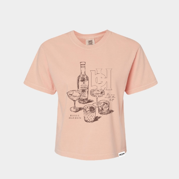Light pink cropped T‑shirt with an illustrated bottle and cocktail glasses on the front.