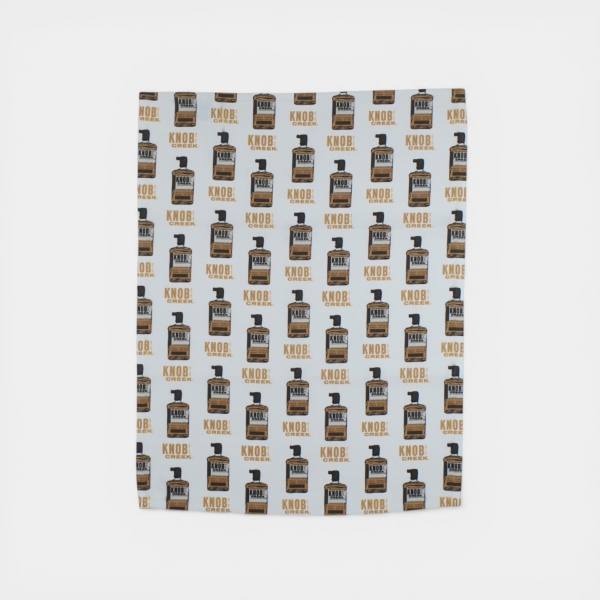 White bar towel with repeating Knob Creek bourbon bottle pattern
