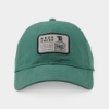 Knob Creek Green Patch Cap in green herringbone fabric with a vintage bottle logo patch on the front.
