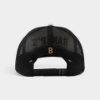 Back of Baker’s Black & Cream Trucker Hat with black mesh panels and adjustable snapback